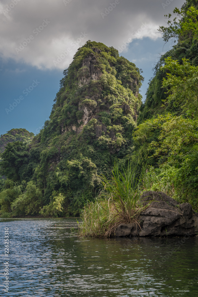 Tourists can view odd karst formations from the water at Trang An and Tam Coc in the Red River delta near Ninh Binh, Vietnam in Southeast Asia. Tourists can view odd karst formations from the water at Trang An and Tam Coc in the Red River delta near Ninh Binh, Vietnam in Southeast Asia.