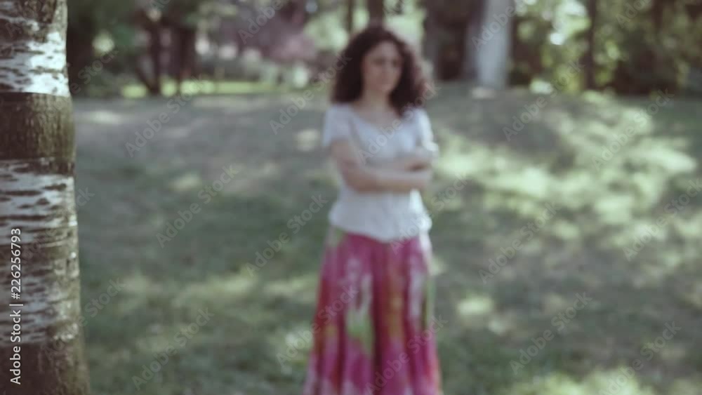 portrait of Blurred sad young woman crying alone in the park- steady cam