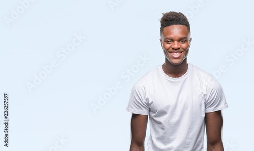 Young african american man over isolated background with a happy and cool smile on face. Lucky person.