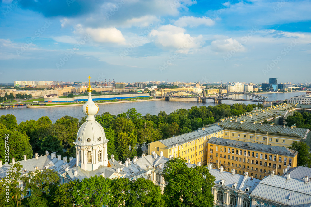 The view from the bell tower of the Smolny Monastery on the Neva and the Bolsheokhtinsky bridge on a summer evening in St. Petersburg. Russia
