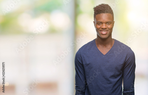 Young african american man over isolated background with a happy and cool smile on face. Lucky person.