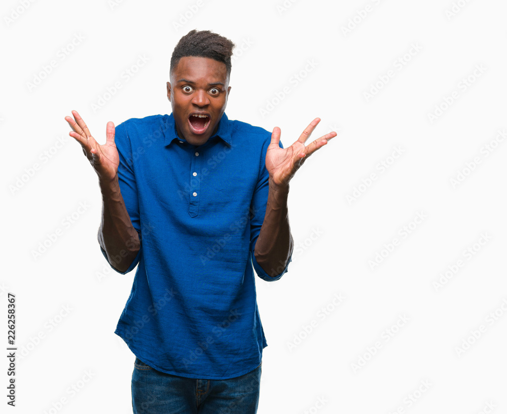 Young african american man over isolated background celebrating crazy and amazed for success with arms raised and open eyes screaming excited. Winner concept Young african american man over isolated background celebrating crazy and amazed for success with arms raised and open eyes screaming excited. Winner concept