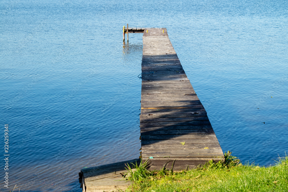 Fototapeta premium An old bridge over the lake. A place for mooring vessels.