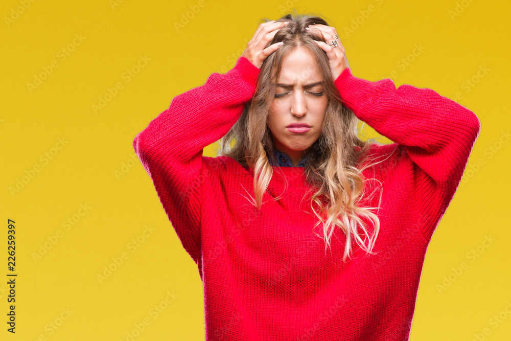 Beautiful young blonde woman wearing winter sweater over isolated background suffering from headache desperate and stressed because pain and migraine. Hands on head. Beautiful young blonde woman wearing winter sweater over isolated background suffering from headache desperate and stressed because pain and migraine. Hands on head.