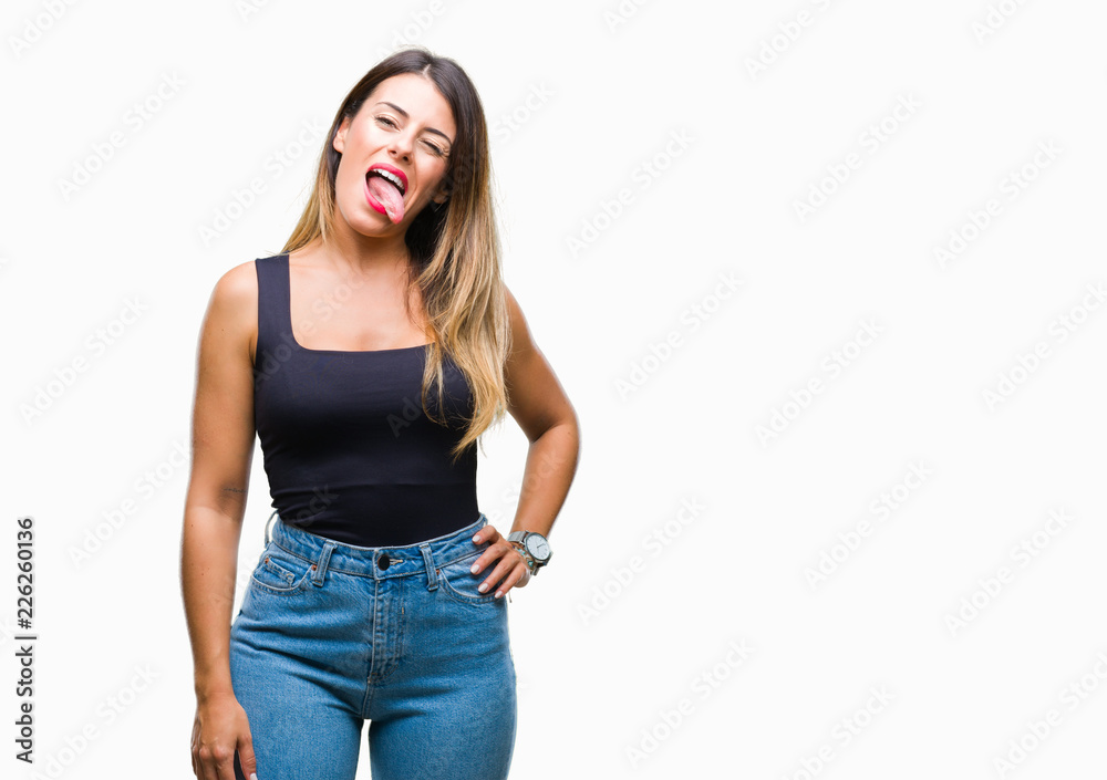 Young beautiful woman over isolated background sticking tongue out happy with funny expression. Emotion concept. Young beautiful woman over isolated background sticking tongue out happy with funny expression. Emotion concept.