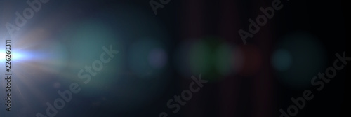 intense blue lens flare effect overlay texture panorama with bokeh effect and light streak in front a black background