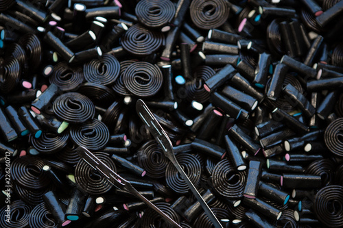 Black Or Brown Candy Spiral Background. Licorice Wheels Candies. Dark Jelly Flavored Licorice. Top View.