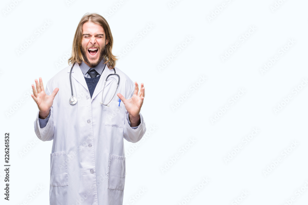Young handsome doctor man with long hair over isolated background celebrating mad and crazy for success with arms raised and closed eyes screaming excited. Winner concept
