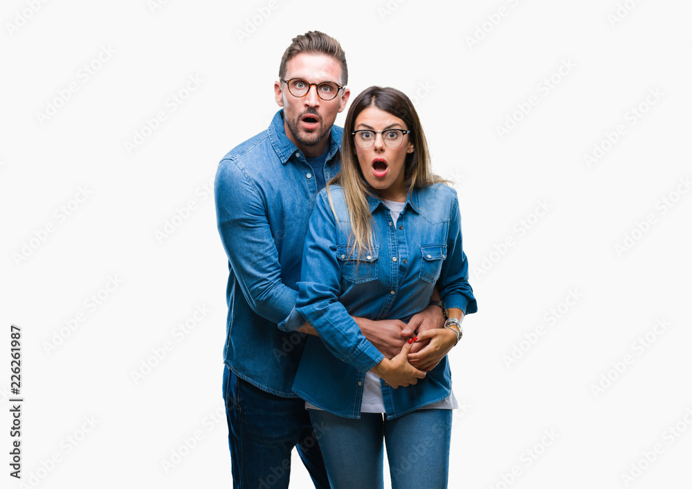 Young couple in love wearing glasses over isolated background afraid and shocked with surprise expression, fear and excited face. Young couple in love wearing glasses over isolated background afraid and shocked with surprise expression, fear and excited face.