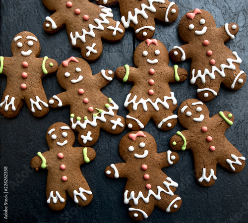 Christmas background with gingerbread menand woman.
