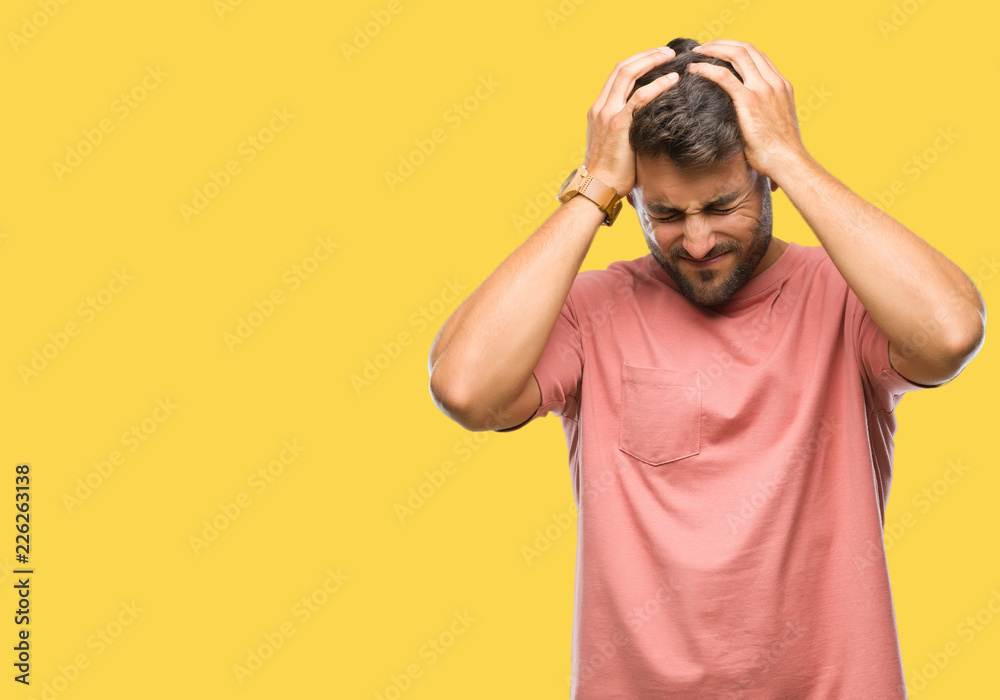 Young handsome man over isolated background suffering from headache desperate and stressed because pain and migraine. Hands on head. Young handsome man over isolated background suffering from headache desperate and stressed because pain and migraine. Hands on head.
