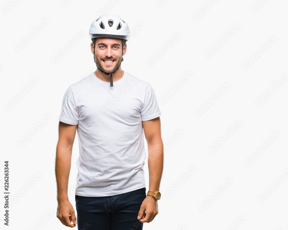 Young handsome man wearing cyclist safety helmet over isolated background with a happy and cool smile on face. Lucky person.