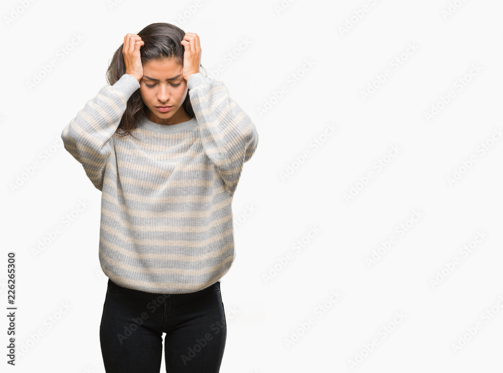 Young beautiful arab woman wearing winter sweater over isolated background suffering from headache desperate and stressed because pain and migraine. Hands on head. Young beautiful arab woman wearing winter sweater over isolated background suffering from headache desperate and stressed because pain and migraine. Hands on head.