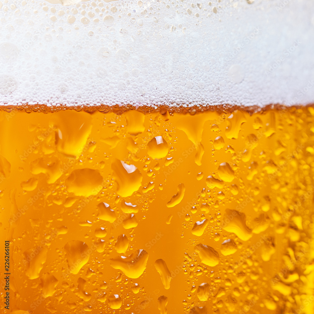 Close up of cold beer in a glass. Beer background