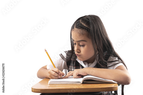 Hispanic girl writing at school