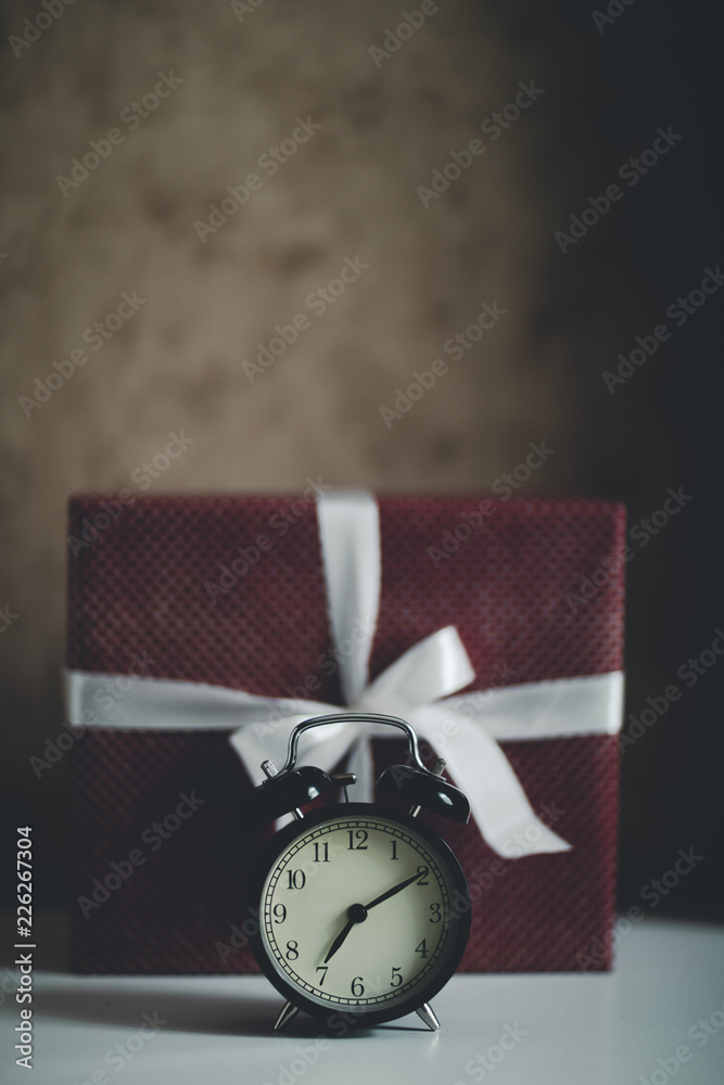 clock on christmas background, Happy New Year: morning clock and gift box clock on christmas background, Happy New Year: morning clock and gift box