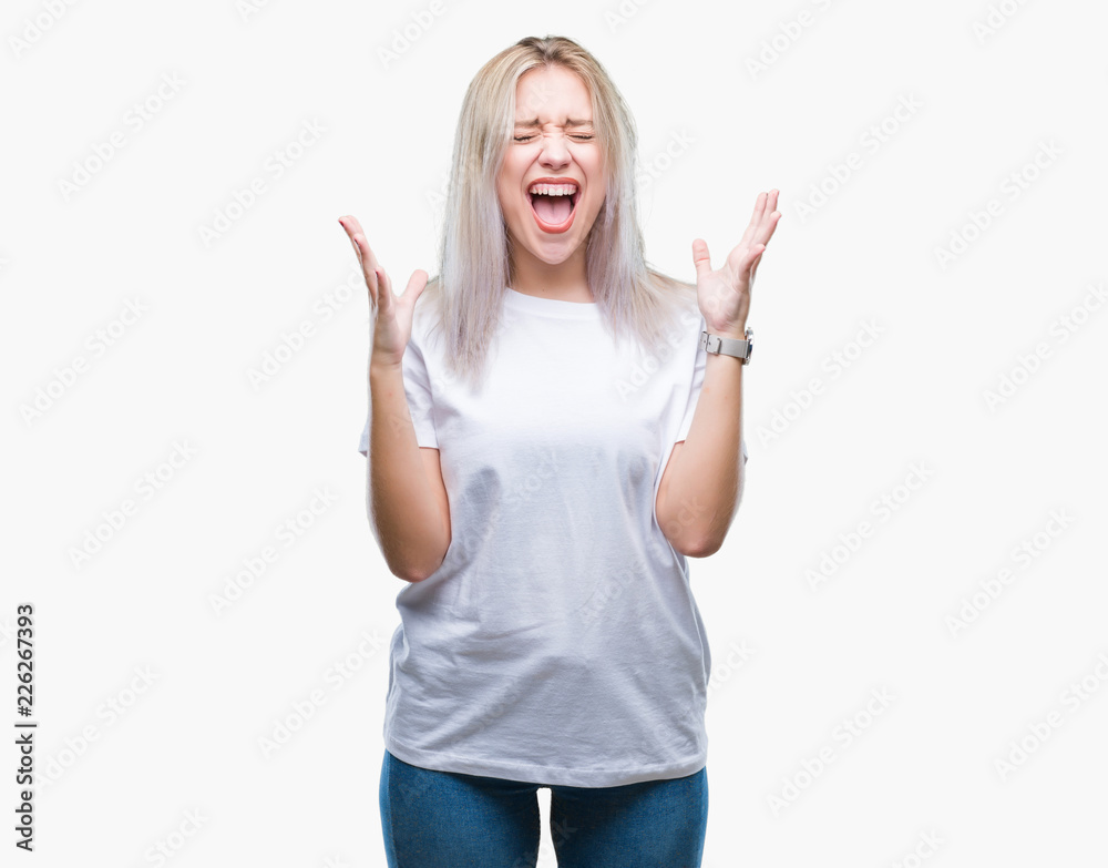 Young blonde woman over isolated background celebrating mad and crazy for success with arms raised and closed eyes screaming excited. Winner concept Young blonde woman over isolated background celebrating mad and crazy for success with arms raised and closed eyes screaming excited. Winner concept