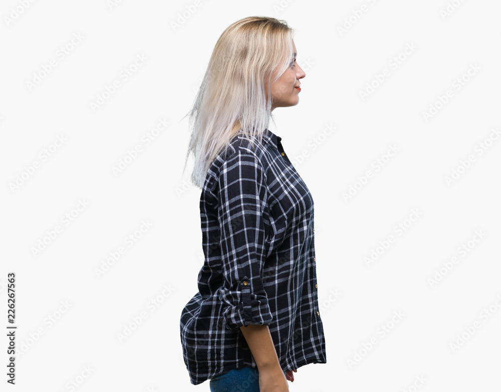 Young blonde woman over isolated background looking to side, relax profile pose with natural face with confident smile. Young blonde woman over isolated background looking to side, relax profile pose with natural face with confident smile.