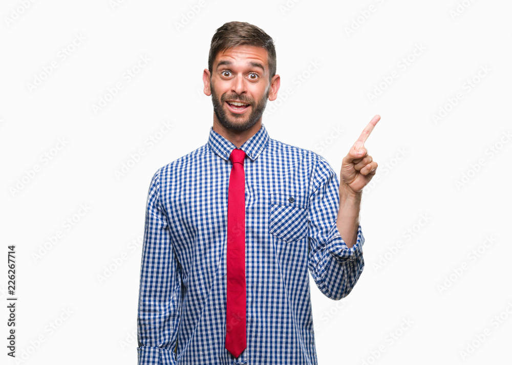 Young handsome business man over isolated background with a big smile on face, pointing with hand and finger to the side looking at the camera. Young handsome business man over isolated background with a big smile on face, pointing with hand and finger to the side looking at the camera.