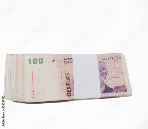 A wad of argentine money. Caption: "Cien pesos" | "One hundred pesos" "Banco Central de la República Argentina" | "Central bank of the Argentinian Republic"