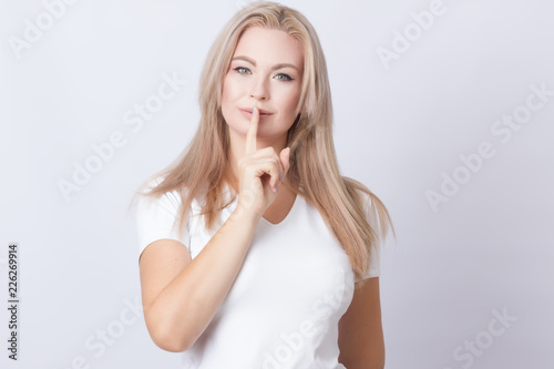 woman with long blonde hair doing stop gesture with hand