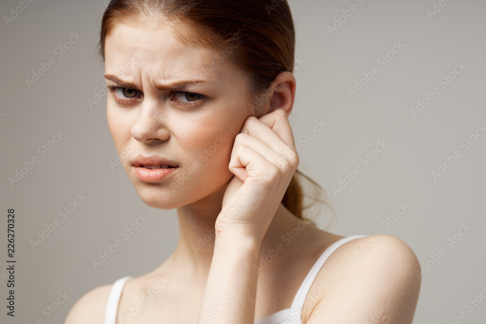 upset woman touching her ear