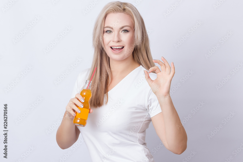 Blonde woman with orange soda in her hands Blonde woman with orange soda in her hands