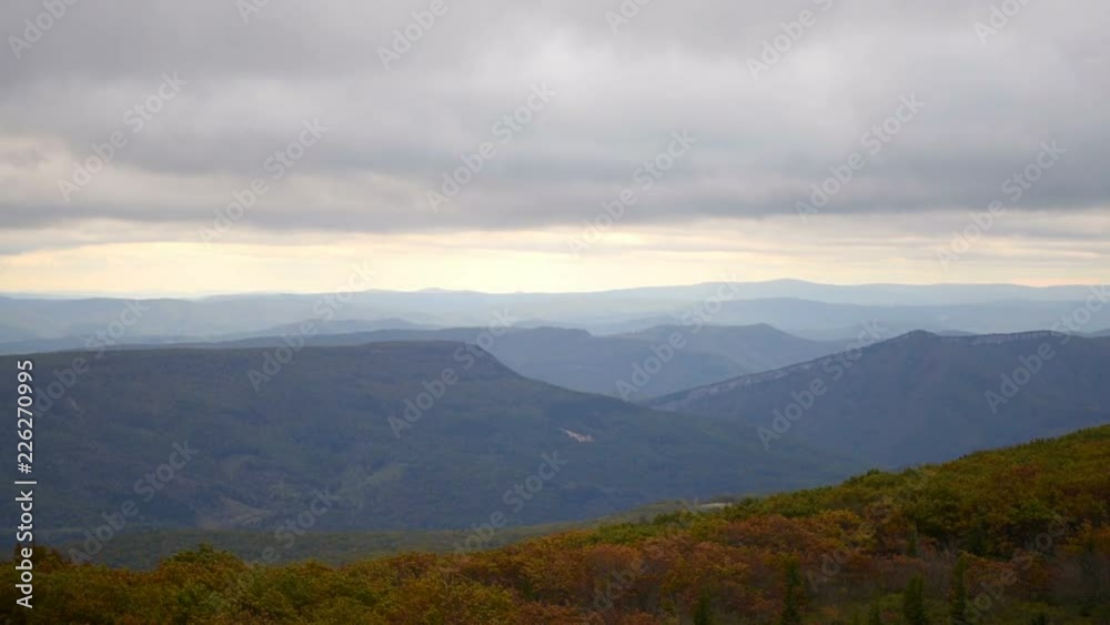 Morning cloudy sunrise with blue sky and golden yellow orange autumn foliage in Dolly Sods, Bear Rocks, West Virginia with overlook of mountain valley, clouds Morning cloudy sunrise with blue sky and golden yellow orange autumn foliage in Dolly Sods, Bear Rocks, West Virginia with overlook of mountain valley, clouds
