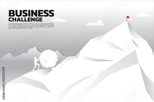 Silhouette of businessman pushing the big rock to the top of mountain. concept of business challenge and hard work.