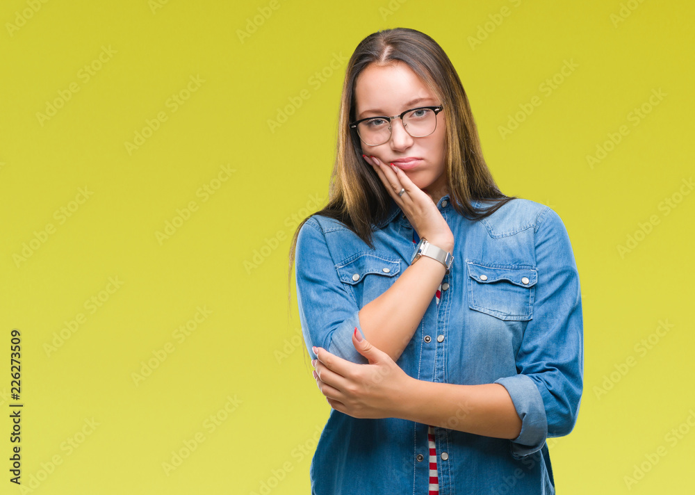 Young beautiful caucasian woman wearing glasses over isolated background thinking looking tired and bored with depression problems with crossed arms. Young beautiful caucasian woman wearing glasses over isolated background thinking looking tired and bored with depression problems with crossed arms.
