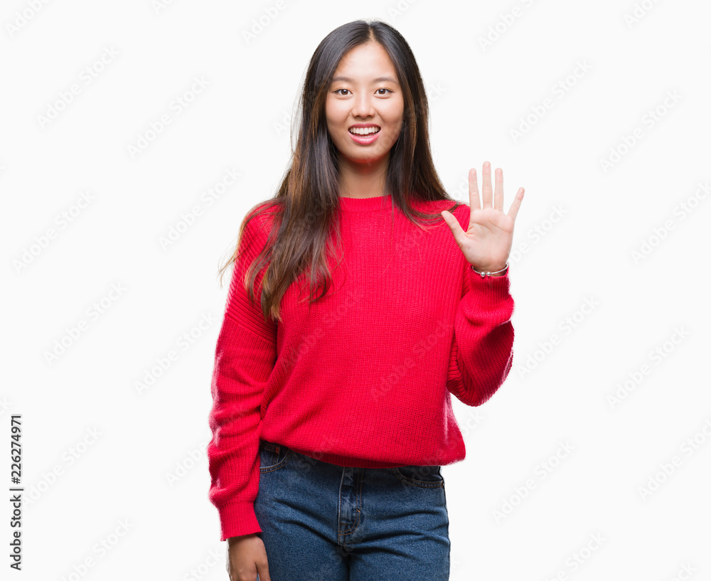 Young asian woman wearing winter sweater over isolated background showing and pointing up with fingers number five while smiling confident and happy. Young asian woman wearing winter sweater over isolated background showing and pointing up with fingers number five while smiling confident and happy.