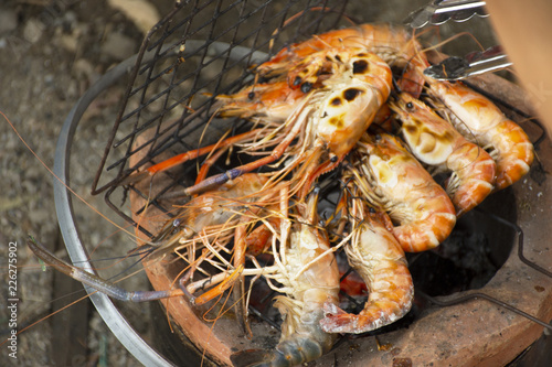 Thai people cooking grill shrimp or prawn on stove