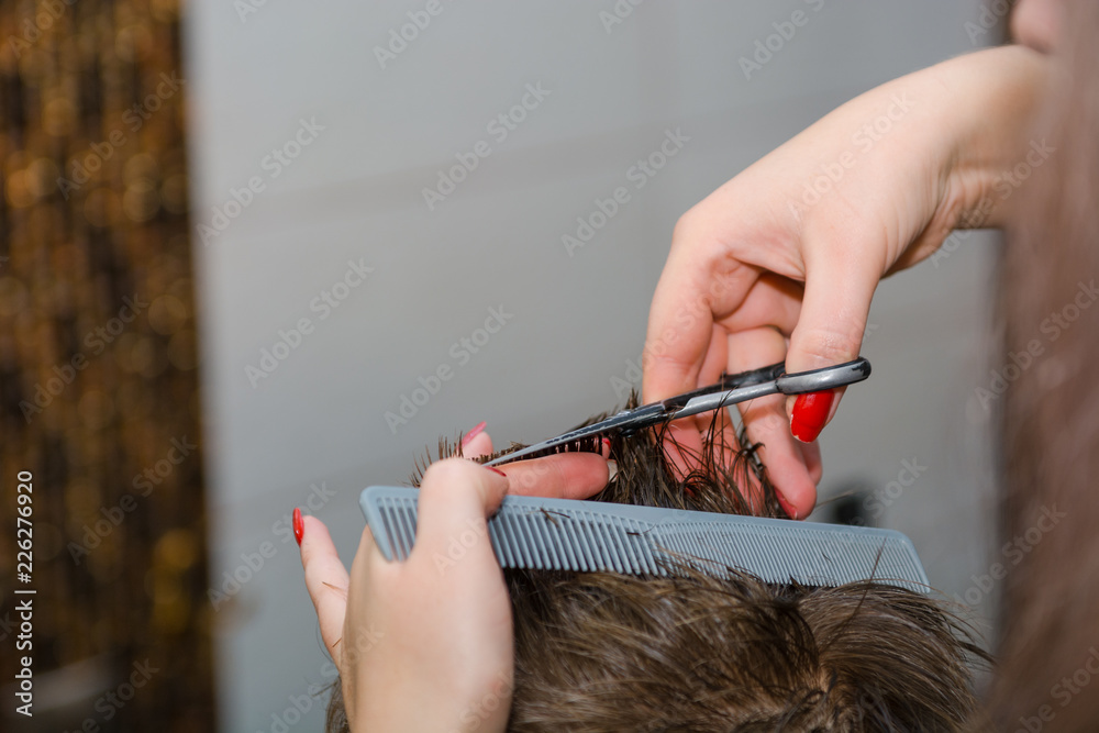 Scissor the hair of a man in a barbershop Scissor the hair of a man in a barbershop