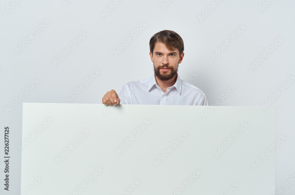 man stands behind a big white drawing paper man stands behind a big white drawing paper