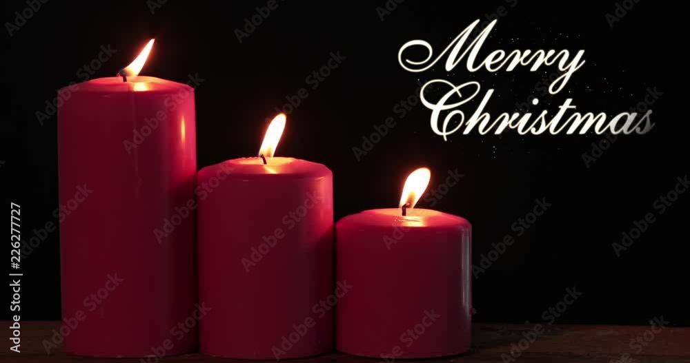 Red Christmas candles with Merry Christmas text and light blowing by wind. Shot in 4k resolution Red Christmas candles with Merry Christmas text and light blowing by wind. Shot in 4k resolution