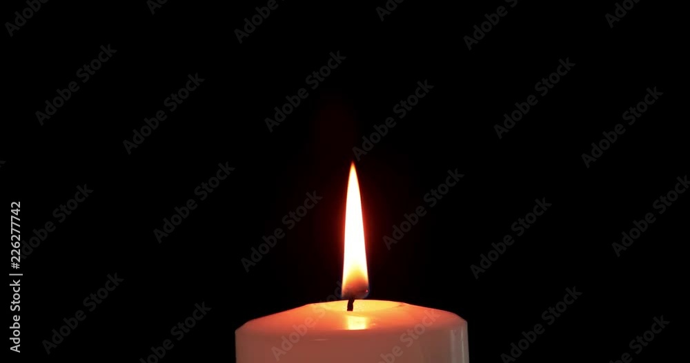 White Christmas candle with golden light on dark background. Shot in 4k resolution White Christmas candle with golden light on dark background. Shot in 4k resolution