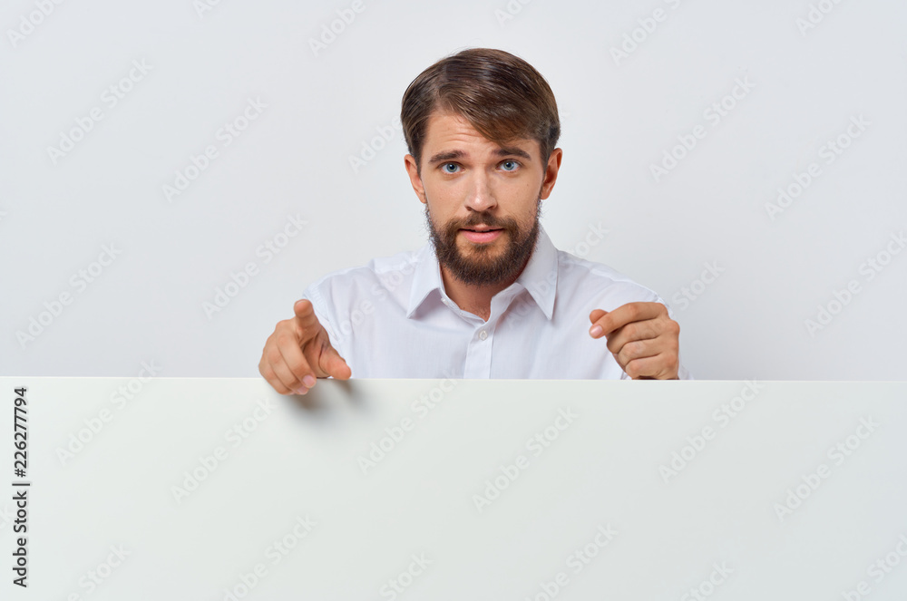 man shows his index finger behind white mockup man shows his index finger behind white mockup