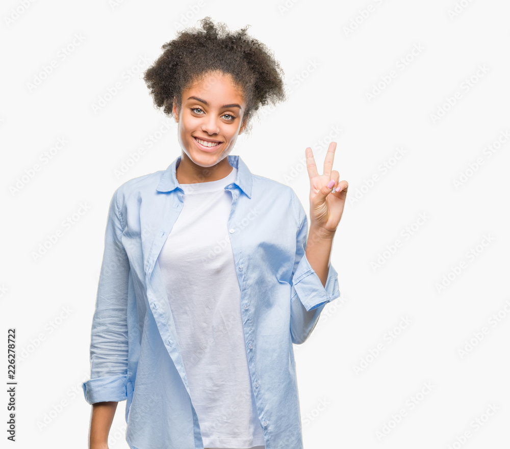 Young afro american woman over isolated background showing and pointing up with fingers number two while smiling confident and happy. Young afro american woman over isolated background showing and pointing up with fingers number two while smiling confident and happy.