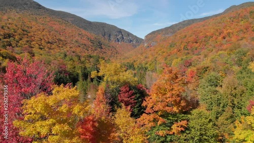 Aerial drone shot of fall foliage and hiking trails through Smugglers Notch, Vermont, USA.