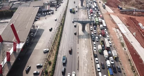 West Java, Indonesia - October 03, 2018: Aerial view of Jakarta-Cikampek toll road with traffic jam and pillars of the elevated toll road project. Shot in 4k resolution photo