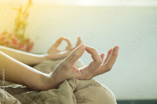 Soft focus of hands do yoga .Young woman do yoga indoors