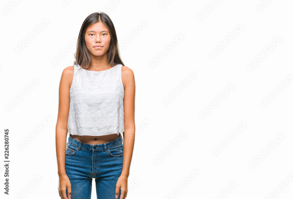 Obraz premium Young asian woman over isolated background with serious expression on face. Simple and natural looking at the camera.