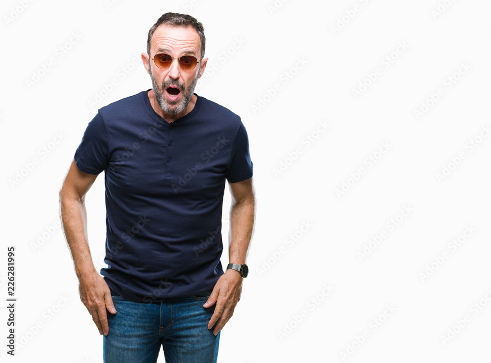 Fototapeta premium Middle age hoary senior man wearing sunglasses over isolated background afraid and shocked with surprise expression, fear and excited face.