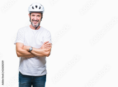 Middle age senior hoary cyclist man wearing bike safety helment isolated background happy face smiling with crossed arms looking at the camera. Positive person.