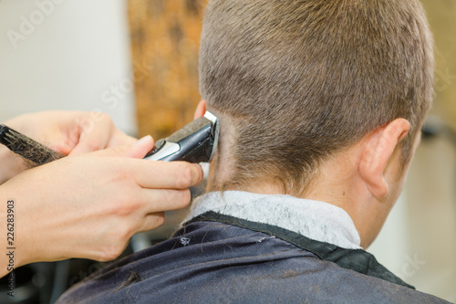 To shave hair to make a haircut for a man with a typewriter