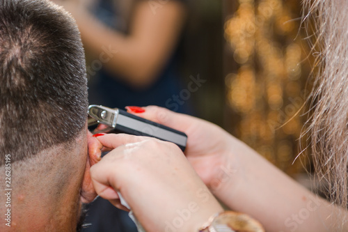 To shave hair to make a haircut for a man with a typewriter