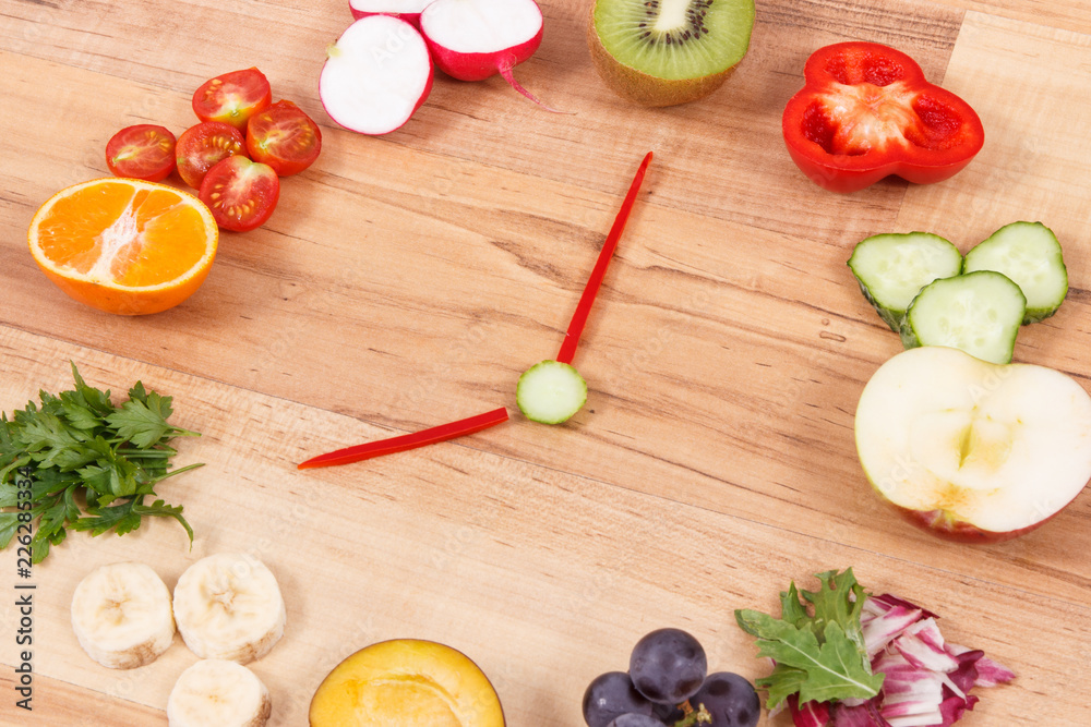 Clock made of nutritious fruits and vegetables showing time 8 am, healthy breakfast concept Clock made of nutritious fruits and vegetables showing time 8 am, healthy breakfast concept