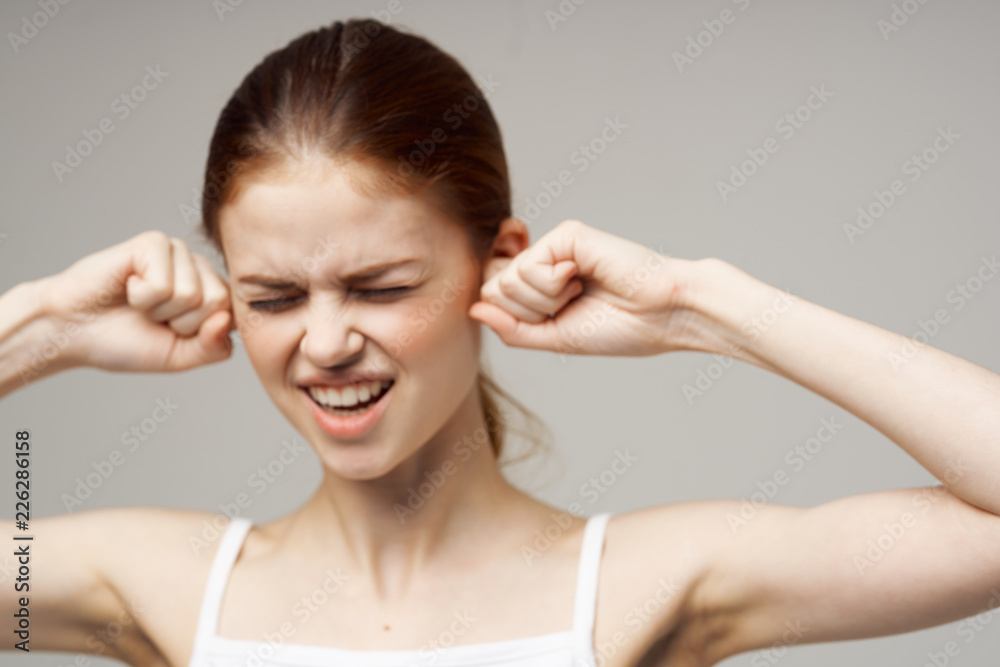 woman with closed eyes fists near face woman with closed eyes fists near face