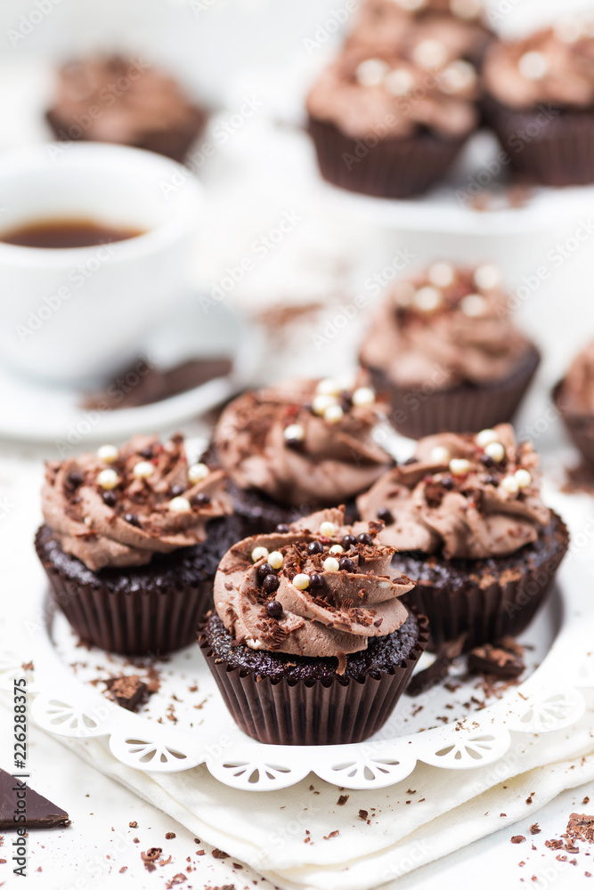 Chocolate cupcakes decorated coffee cheese cream on a white plate Chocolate cupcakes decorated coffee cheese cream on a white plate