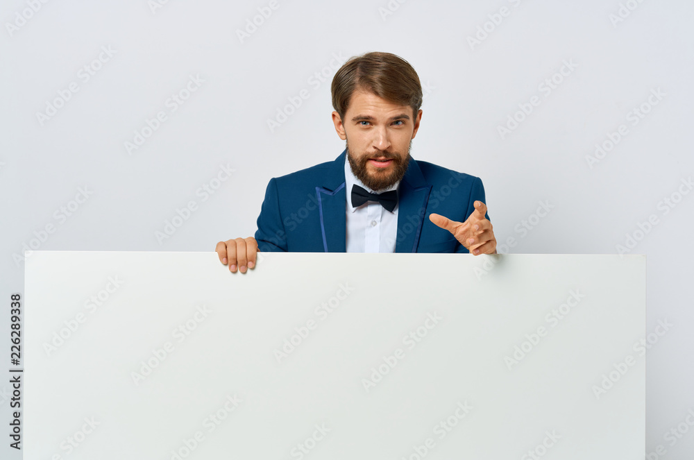 a man in a suit is standing behind a big white drawing paper mockup a man in a suit is standing behind a big white drawing paper mockup